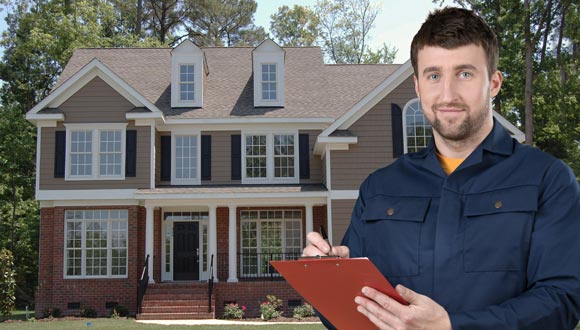 A home inspector in Greensboro, NC — in front of a house, going over the checklist.